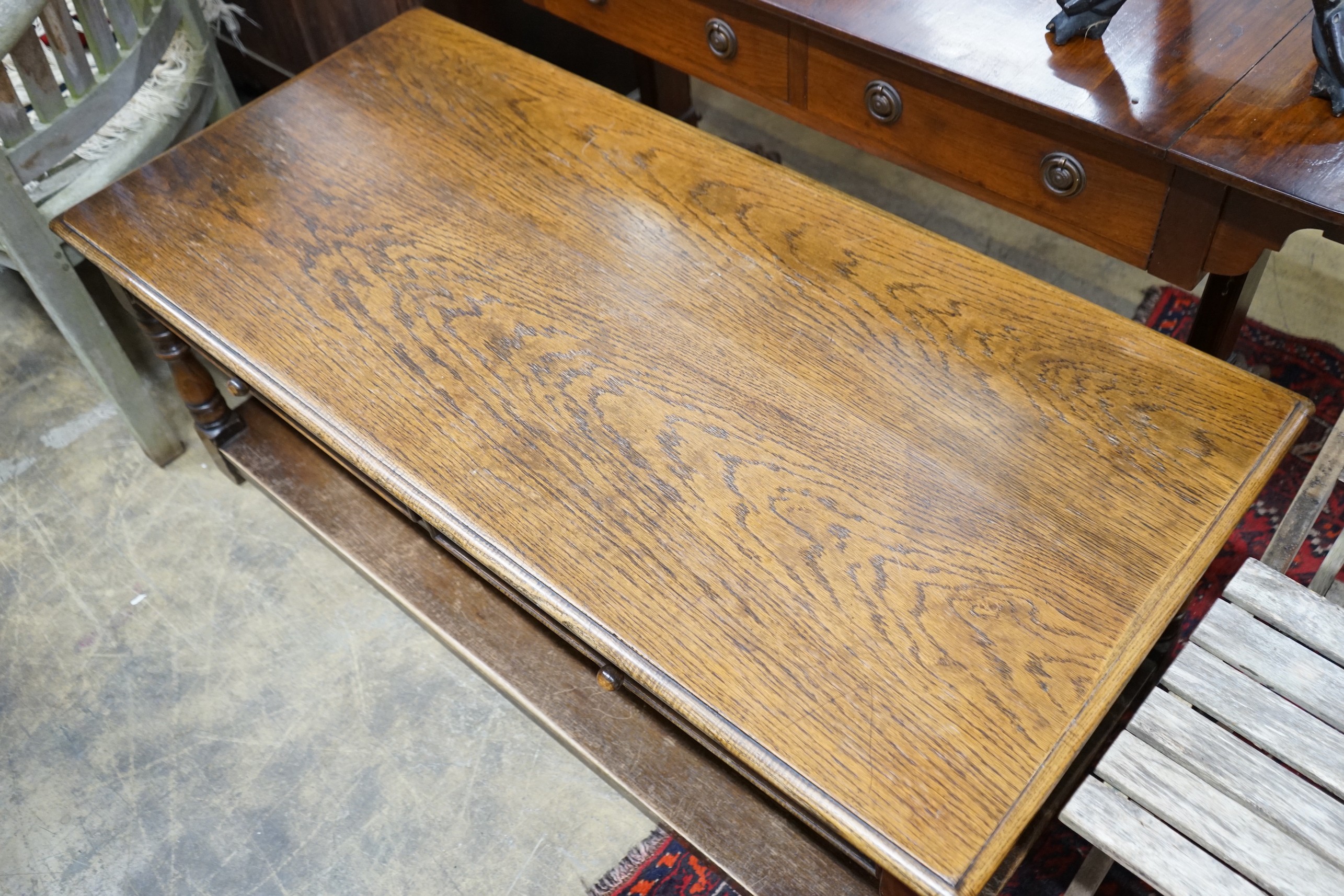 An 18th century style rectangular oak two tier coffee table, length 130cm, depth 62cm, height 50cm